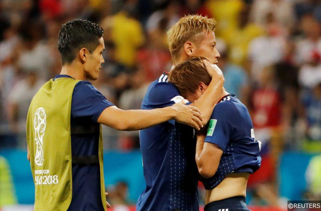 Japan's players console each other after their 2018 World Cup Last 16 loss to Belgium