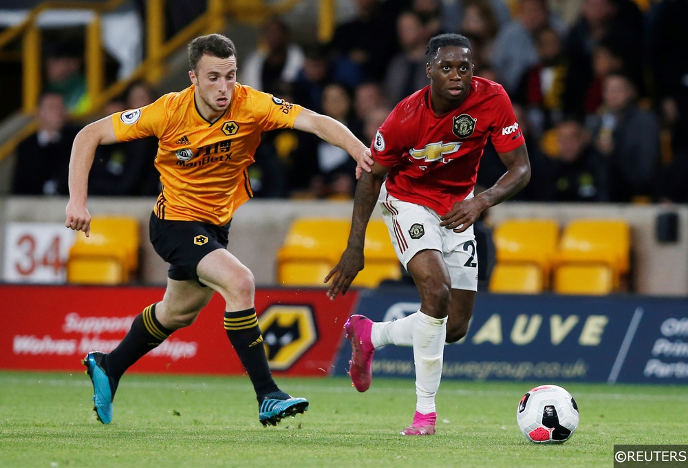 Man United's Aaron Wan-Bissak dribbles past Wolves' Diogo Jota