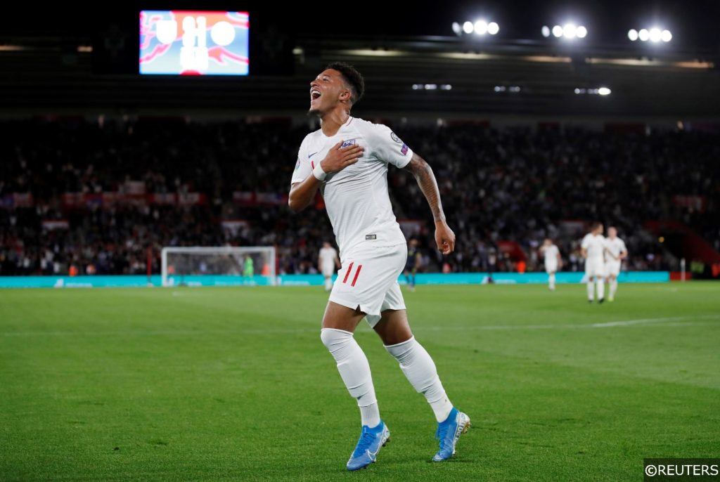 Jadon Sancho celebrates scoring his first goal for England