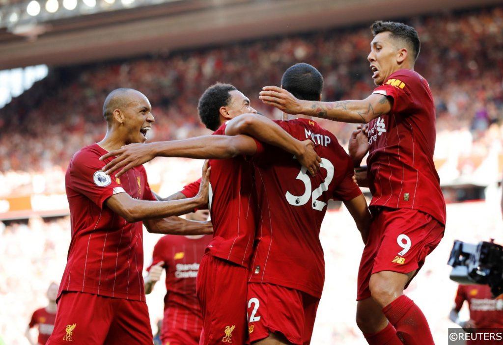 Fabinho and Firmino celebrate with Matip after goal vs Arsenal